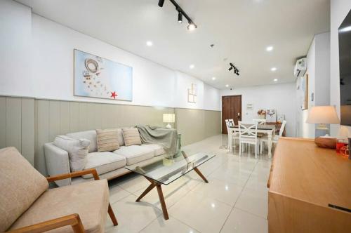 a living room with a couch and a table at Rio House district 10 Saigon Centrosa in Ho Chi Minh City