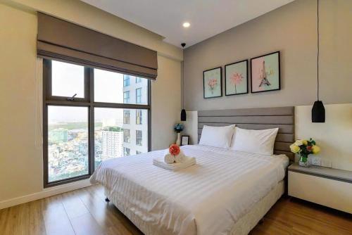 a bedroom with a large bed and a large window at Rio House district 10 Saigon Centrosa in Ho Chi Minh City