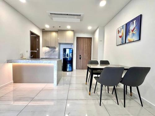 a dining room with a table and chairs and a kitchen at Rio House district 10 Saigon Centrosa in Ho Chi Minh City