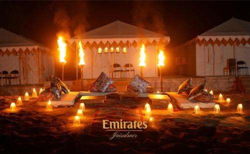 a group of lit candles in front of a tent at Emirates Luxury Desert Camps in Jaisalmer