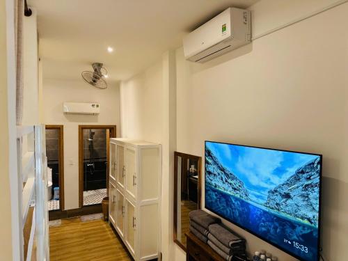 a living room with a flat screen tv on a wall at Myhoa Lagoon - Kiting Town in Phan Rang