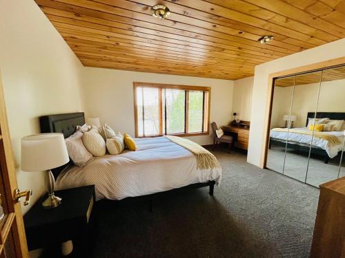 a bedroom with a large bed and a mirror at The River Retreat in Baldwinsville