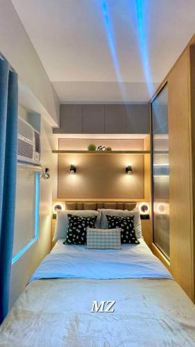 a bedroom with a king sized bed in a room at Cozy Corner Haven near Venice Grand Canal Mall in Manila