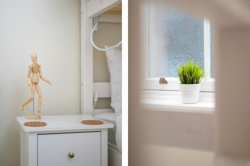 a room with a window and a mannequin on a table at Escape to Serene Georgian Estate, near Edinburgh in Ratho