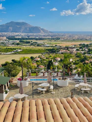 a view of a resort with a pool and tables and umbrellas at B&B Sole e Luna in Palermo