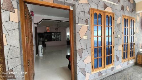 an open door into a room with a hallway at Villa in Kollam