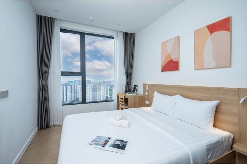 Ένα ή περισσότερα κρεβάτια σε δωμάτιο στο NU Apartment in Lumiere Riverside - Central District 2