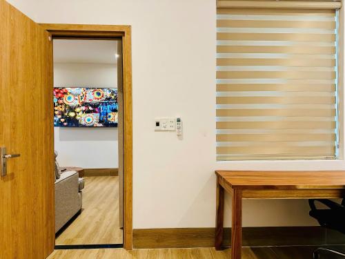 a room with a window with a desk and a television at Myhoa Lagoon - Kiting Town in Phan Rang