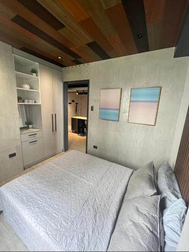 a bedroom with a white bed in a room at Urban Luxe Oasis in Bacolod