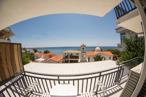 a balcony with a view of the ocean at Sappho Plomari in Plomarion