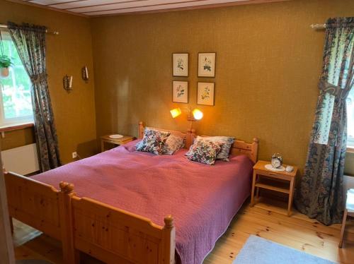 a bedroom with a bed with a red bedspread at Paradise in Bergslagen in Fagersta