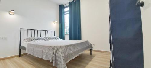a bedroom with a bed and a large window at Apartments Black Pearl of Ureki in Ureki