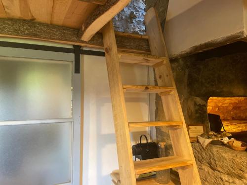 a wooden shelf in a room next to a door at Tiny House El Forn de La Pegatera in Coll de Nargó