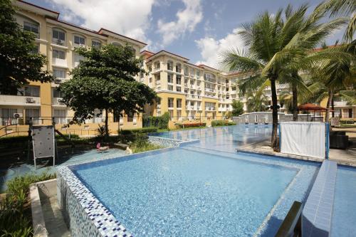 a large swimming pool in front of a building at San Remo Condo in Cebu City