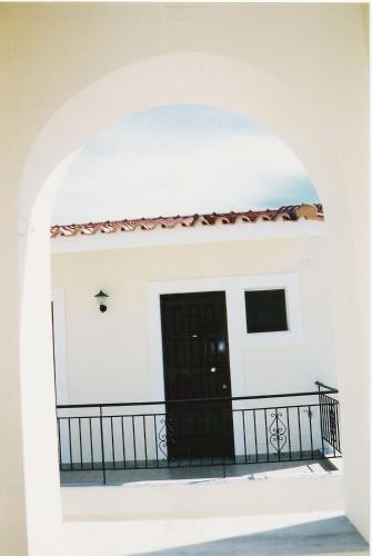 a room with a balcony and a black door at Valias House in Finikounta