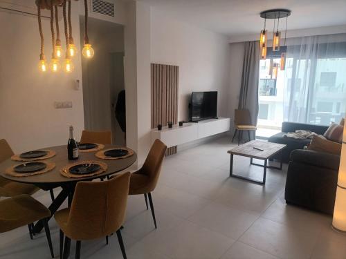a living room with a table and chairs and a couch at Cosy Casa New penthouse in San Miguel de Salinas