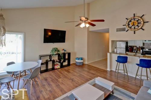 a living room with a table and chairs and a kitchen at Gulfpoint 1302 in South Padre Island