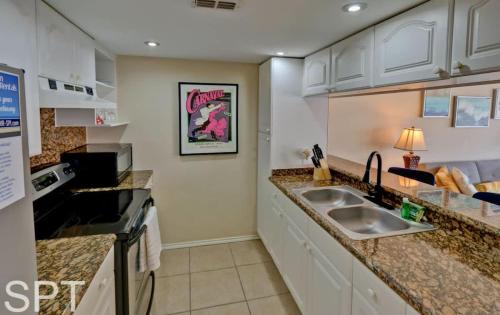 a kitchen with a sink and a counter top at Gulfpoint 1302 in South Padre Island