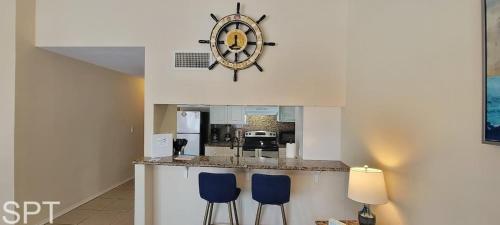 a large clock on the wall above a kitchen counter at Gulfpoint 1302 in South Padre Island