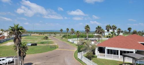 an aerial view of a resort with palm trees and a road at Gulfpoint 1302 in South Padre Island