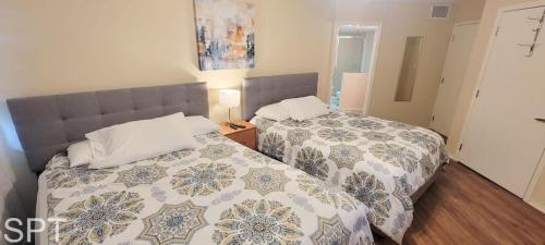 a bedroom with two beds and a night stand at Gulfpoint 1302 in South Padre Island