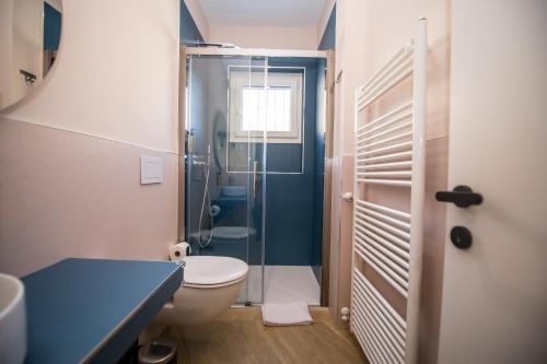 a bathroom with a toilet and a glass shower at Show MI Rooms Milano - San Siro Stadio - Ippodromo - Rho Fiera in Milan