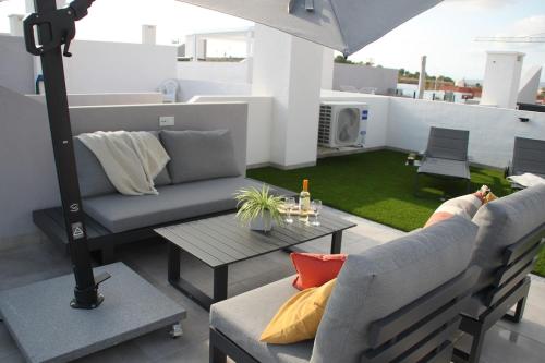 a living room with a couch and a table at Cosy Casa New penthouse in San Miguel de Salinas