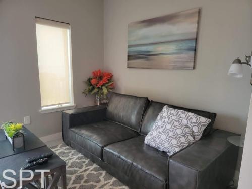 a black leather couch in a living room at Bungalow Tarvana-#1 in Port Isabel