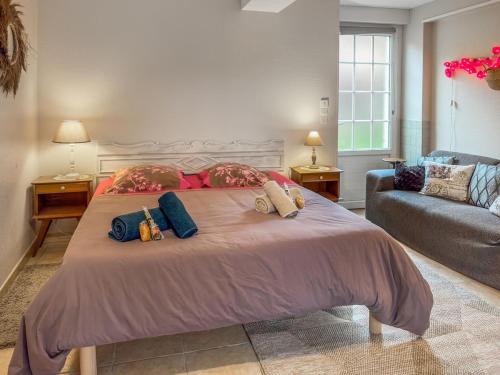 a bedroom with a large bed with two pillows on it at L'Écrin Normand in La Ferté-Macé