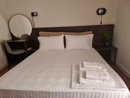 a bedroom with a bed with two towels on it at KC Apartments 3 in Berat