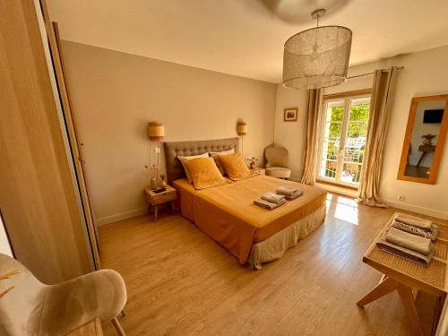 a bedroom with a bed with yellow pillows on it at Le Mas Justin in Gordes