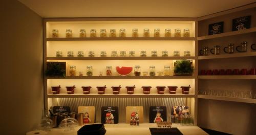 a shelf filled with lots of glass bottles at Sappho Plomari in Plomarion