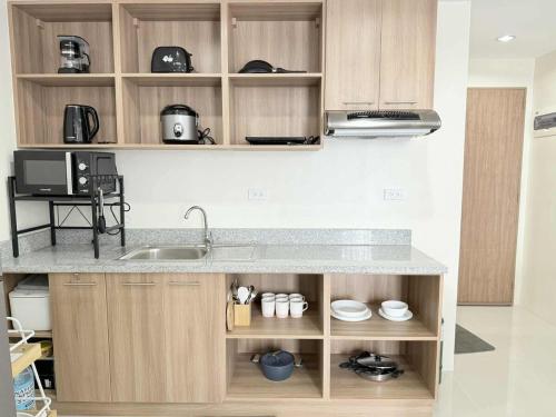a kitchen with a sink and a counter top at Condo with Balcony near Mactan Newtown in Mactan