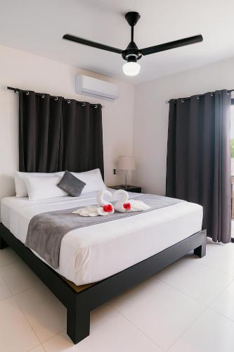 a bedroom with a large bed with black curtains at Fully Serviced Apartment with 24h Power, Security and Wi-Fi in Sosúa