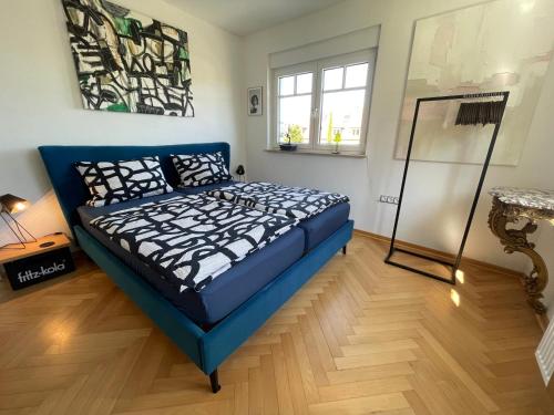 a bedroom with a blue bed in a room at Schönste Location in Würzburg in Würzburg