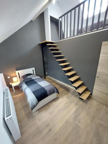 a bedroom with a bed and a spiral staircase at Villa d'Houthem in Kasteelhoek