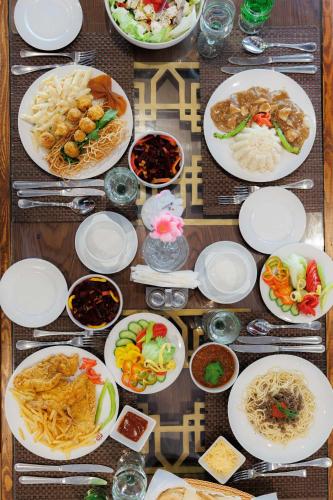 a table full of plates of food on a table at Amoun Hotel Alexandria in Alexandria