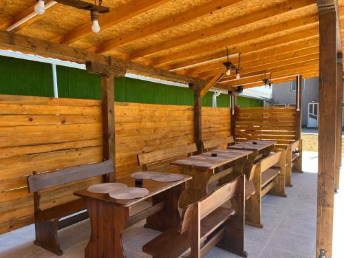 a row of wooden benches in a room with green walls at Къща за гости Галанти Guest house Galanti in Orchenlar