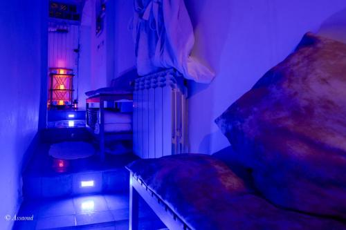 a dark room with a bed and a radiator at Riad Alia Suites SPA in Chefchaouene