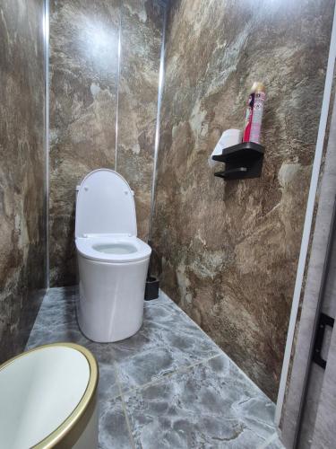a bathroom with a toilet and a sink at Hostel Navi Osh in Osh