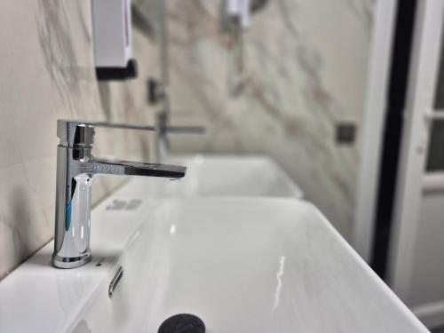 a sink with a faucet in a bathroom at Hostel Navi Osh in Osh