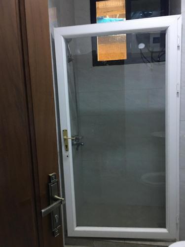 a glass door to a shower in a bathroom at Apple Luxury Apartments in Kigali