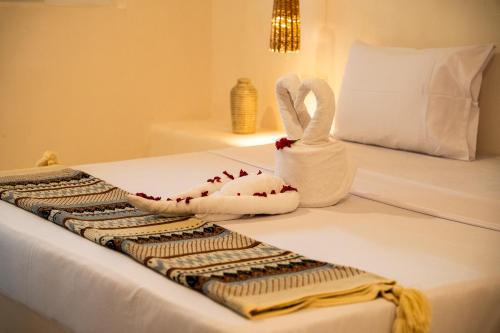 a hotel room with two towels on a bed at Hostel 197 in Nungwi