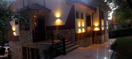 a house with lights on the side of it at Vila na Rtnju in Rtanj
