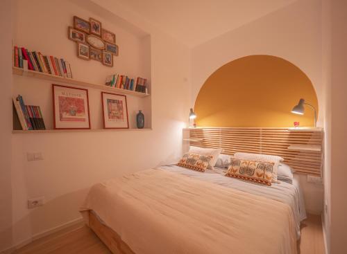 a bedroom with a bed with an arch above it at La Casa di Nina e la Luna in Perugia