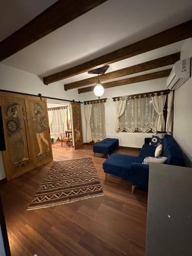 a living room with a blue couch and a rug at Saint Johns Hill Boutique Ephesus in Selcuk