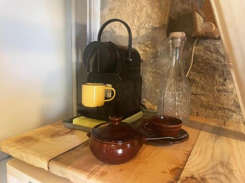 a wooden cutting board with cups and a coffee maker at Tiny House El Forn de La Pegatera in Coll de Nargó