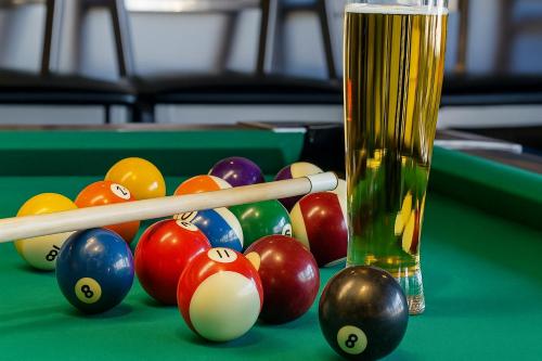 a group of billiard balls and a glass on a pool table at Hotel Max Comfort in Kutaisi