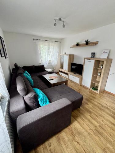 a living room with a couch and a television at Ataman in Hessisch Oldendorf
