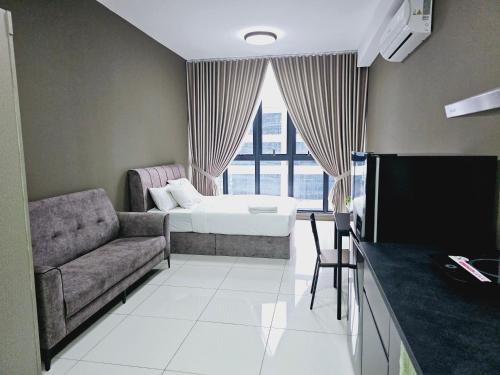 a living room with a couch and a bed at Gen Majestic Residence Kuala Lumpur in Kuala Lumpur